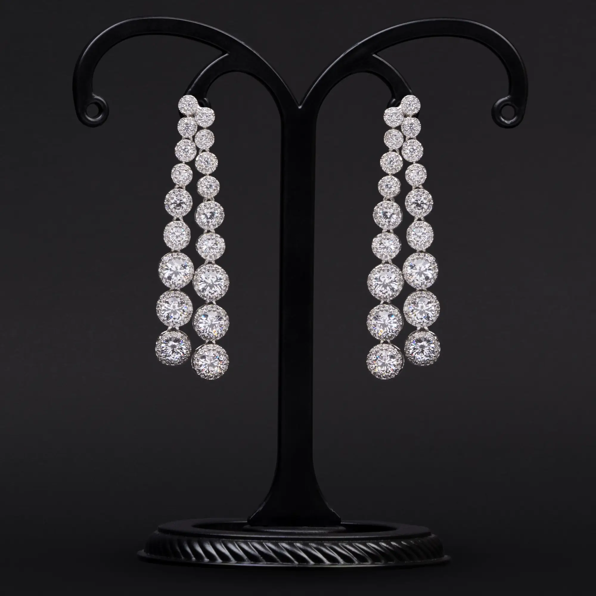 Two Lines of Rhodium Polished Danglers with Solitaires and American Diamonds